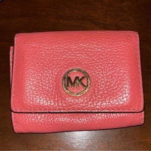Michael Kors small coral, pink flip wallet.